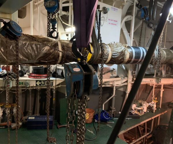 View of the intermediate propeller shaft in the engine room. The intermediate shaft is suspended so that the terminal shaft can be pulled in