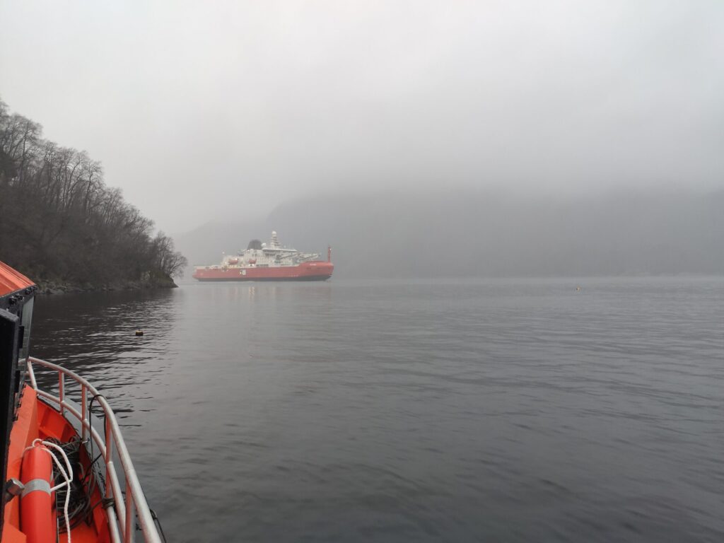 The Australian supply and research vessel RSV Nuyina (the icebreaker) during underwater noise measurements on the mobile noise measurement track in a fjord in Norway.