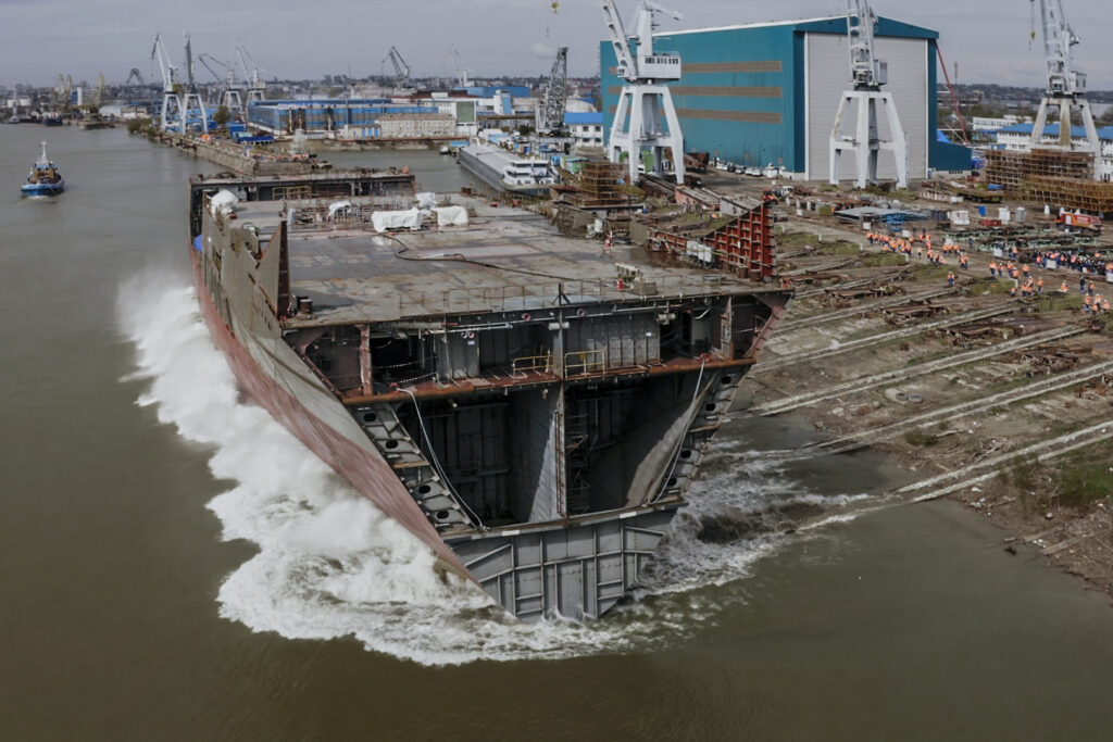 The hull section slid smoothly into the water of the Danube.