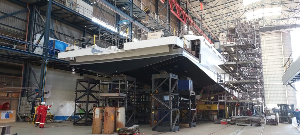 The rear two sections were placed against the ship in June.