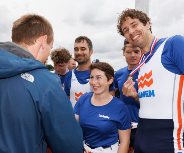 Coxswain Ricarda Lang receivers her winner's medal.