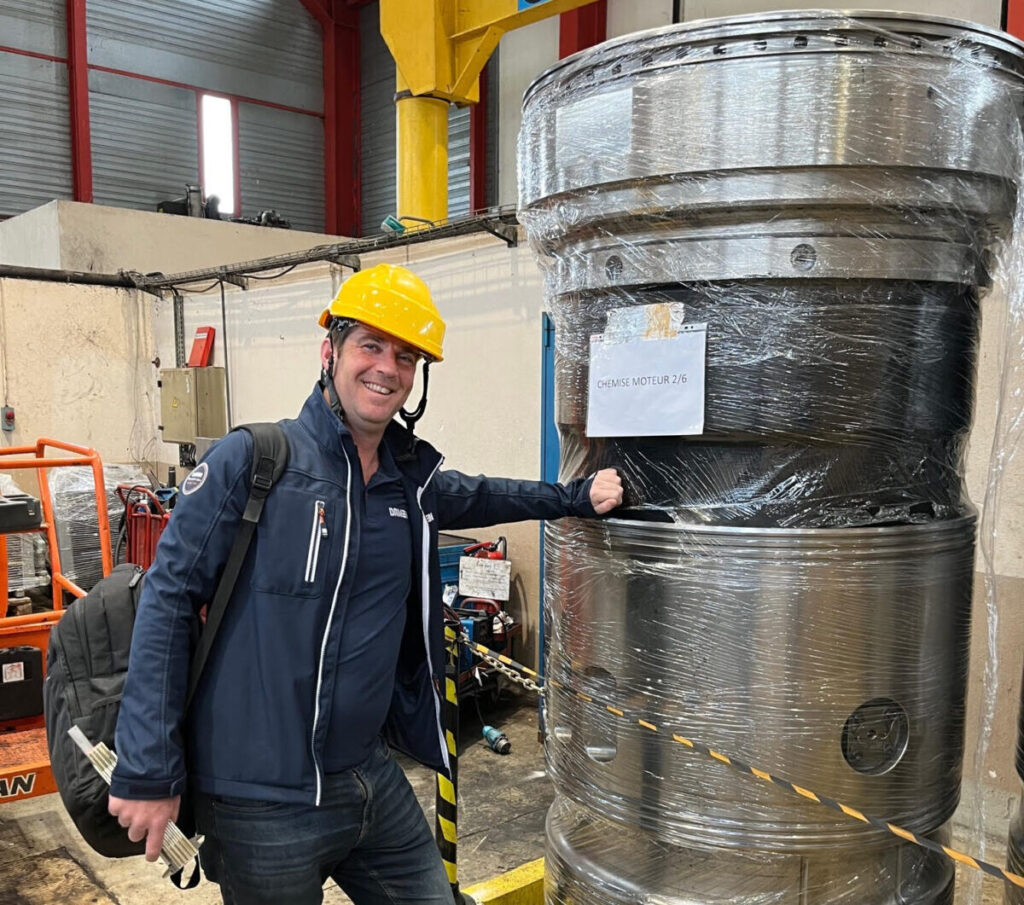 DSMS Sales Manager Richard Nieuwenhuize stands next to a cylinder liner for one of the Sulzer RND90M engines.